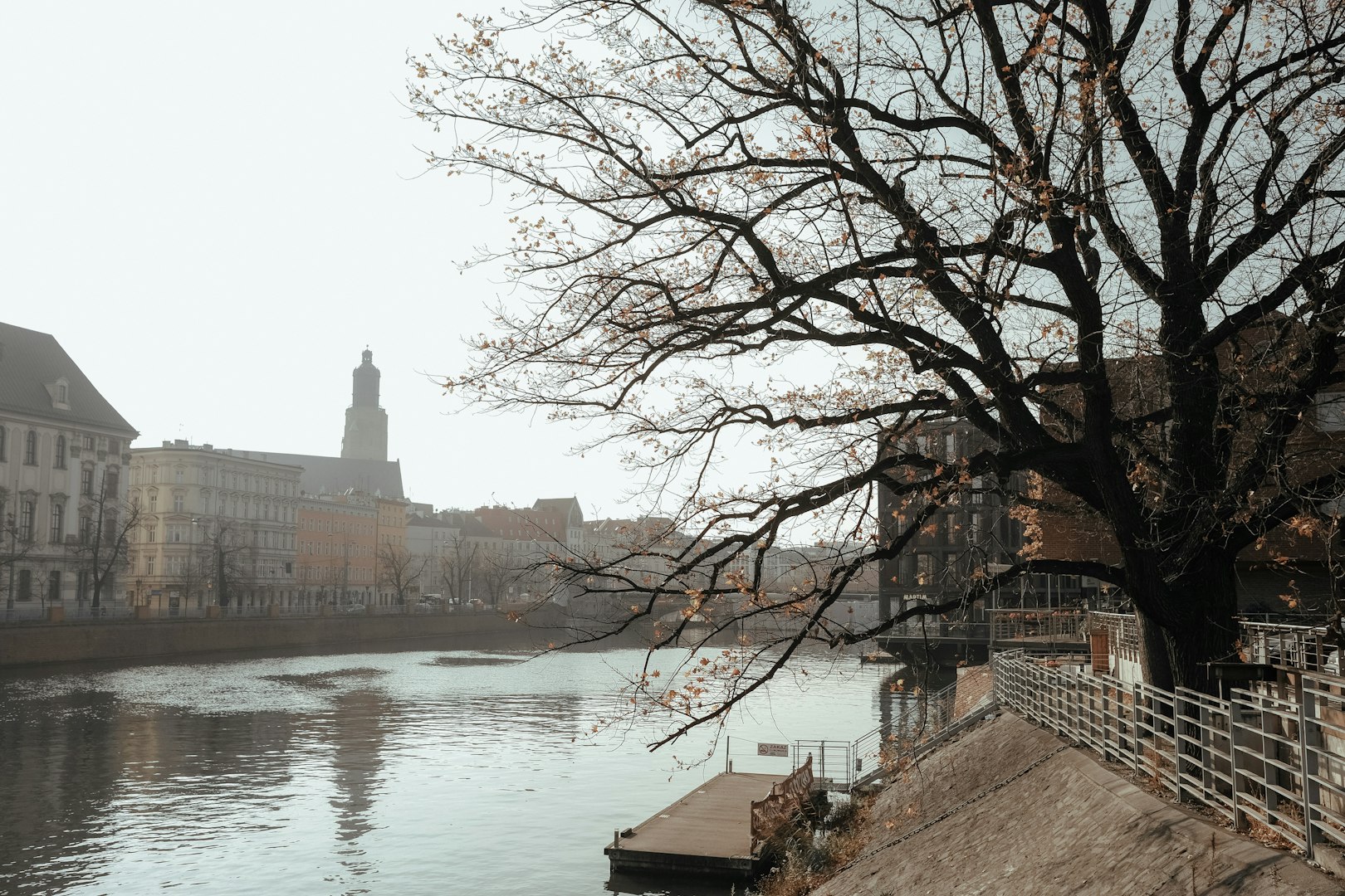 a river running through a city next to tall buildings